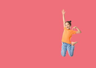 Cute girl jumping on pale red background, space for text
