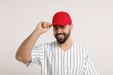 Man in stylish red baseball cap on white background