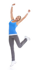 Woman, fitness celebration and yes in studio for exercise, workout achievement and body goals or dance. Sports model with fist, energy or surprise portrait for training results on a white background
