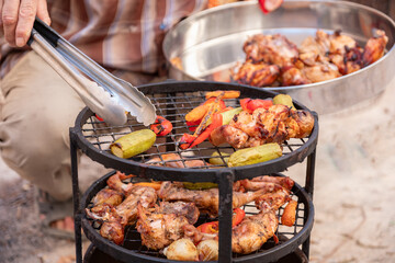 Zurbian dinner. The barrel has been uncovered and it is ready and well cooked. It contains chicken, vegetables and rice. It is placed on a wire rack and it has been transferred to the serving tray.