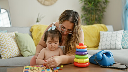 Mother and daughter share a lovely learning moment together, playing a mathematics game on the...