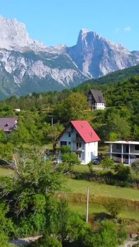 Aerial drone view of the rustic homes and hotels of Theth National Park, Albania. Albanian Alps