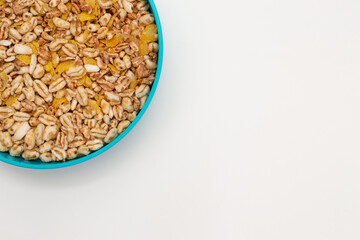 Bowl of puffed wheat and unsweetened corn. Vegan breakfast. Top view.
