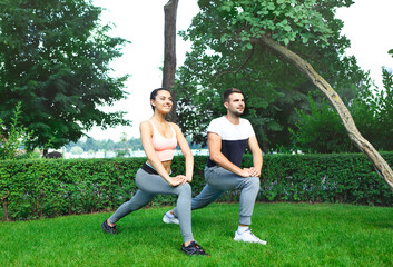 Young couple exercising and stretching muscles before sport activity
