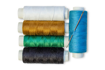 Several spools of multi-colored threads with a needle. Isolated on transparent background.