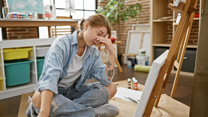 Young woman artist looking draw stressed at art studio