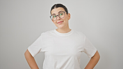 Young beautiful hispanic woman smiling standing with arms akimbo over isolated white background