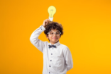 Child boy holding paper bulb. Success, motivation, winner, genius, idea concept