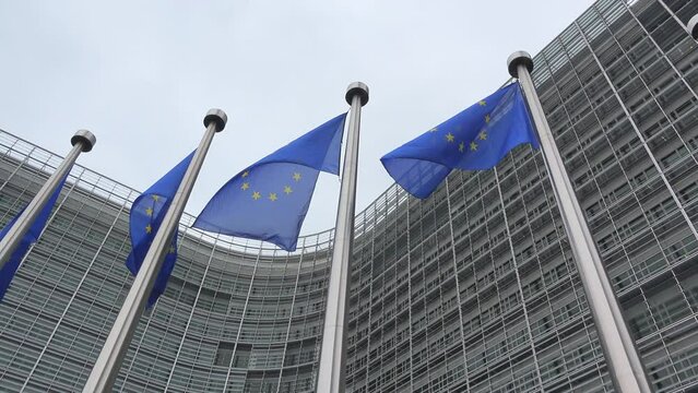 EU flags waving in front of European Commission building in Brussels, Belgium