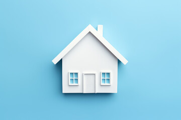 A white house symbol against a light blue backdrop, this image reflects the real estate market and the nuances of home financing and mortgage.