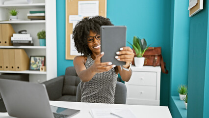 African american woman business worker make selfie by touchpad at the office