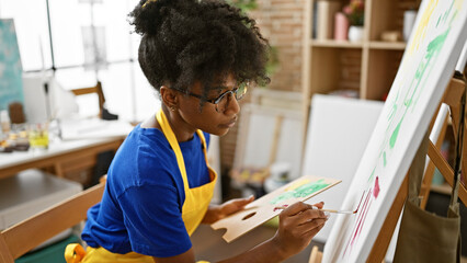 African american woman artist drawing at art studio