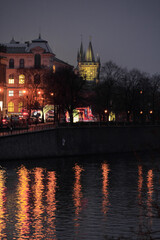 Obraz premium The river Vltava in Prague and some buildings and the night life in the background