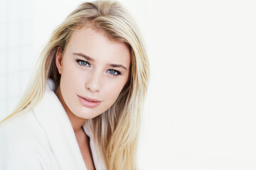 Naklejka premium Portrait, woman and blonde on mockup space for makeup, cosmetics or beauty in bathroom at home. Face of attractive, gorgeous or young female person or model in satisfaction for facial spa treatment