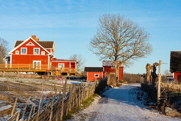 Typical red wooden house in Sweden in winter in the Bråbyggden area in eastern Småland. The photo...