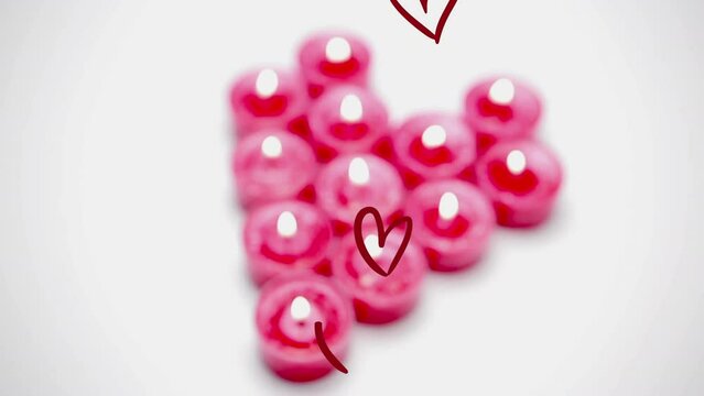 Animation of multiple red hearts over pink candles