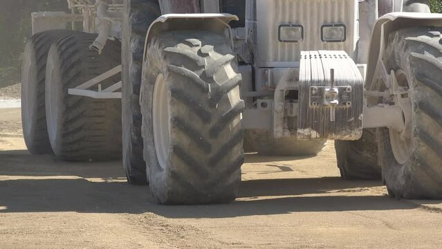 Detail of tractor tires carry the building materials on construction site