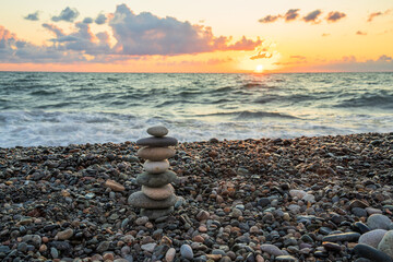 Balancing Act: Sea Stones Stacked on Seashore