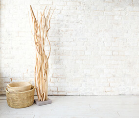 Stylish plant and wicker basket in room