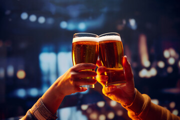 Two hands holding big mug of lager unfiltered foamy beer and clinking. Two friends sitting in bar and drinking alcohol drinks. Concept of Oktoberfest, party, celebration, taste, national traditions. - obrazy, fototapety, plakaty