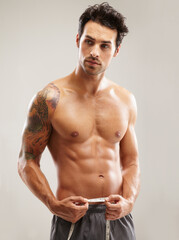 Six pack, healthy or man with tape measure for fitness, body growth or workout in studio on grey...