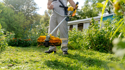 lawn trimmer on a green lawn on a sunny day