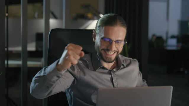 Business achieve online computer achievement startup offer opportunity approval bid Caucasian man businessman male worker company CEO at evening office ecstatic employer euphoria laptop win success