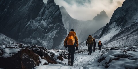 Adventurers trekking through a snowy mountain pass wearing backpacks - obrazy, fototapety, plakaty