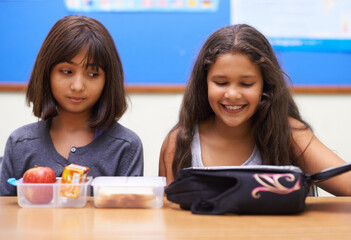 Happy kids, students and eating food in classroom at school for meal, break or snack time. Young...