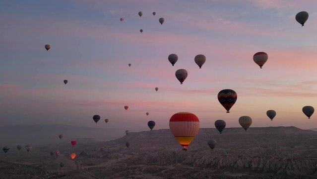 Hot air balloon flight in Goreme in Turkey during sunrise. Ride in a hot air balloon, the most popular activity in Cappadocia. Romantic and famous travel destination.