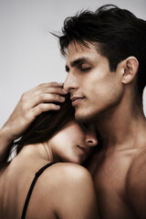 Obraz premium Couple, man and woman hug for love, security with affection and bonding isolated on white background. Peace, support and people in relationship with tender moment in studio, trust and commitment