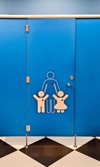 Fototapeta na wymiar Shared family bright restroom in airport, mall. Unisex WC for mom, dad,little girl boy,child kid. Use together. Recreation room, toilet for adults, daughter,son. Separate cabins for parents,children