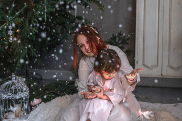 mother and son in white with wings in the Christmas studio