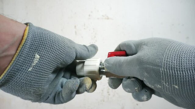 A plumber connects polypropylene pipes.