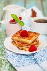 Delicious breakfast with fresh coffee, fresh waffles and fruits