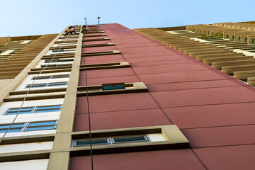 High rise cleaning man hanging on rope access doing high building cleaning service, risk work and work on height concept