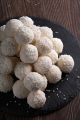 Homemade sweet delight: a coconut ball. This tempting dessert , creating a heavenly treat. A delightful confection, perfect for those with a sweet tooth seeking a homemade indulgence.