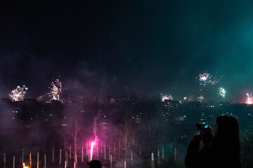 Fototapeta na wymiar Capturing the Magic of New Year's Eve: Berlin Skyline Illuminated by Dazzling Fireworks Celebration in a City Alive with Joy and Lights