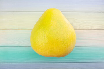 one pomelo on wood background