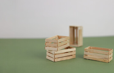 Several wooden boxes stand on an olive background