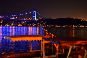 night view of the bosphorus bridge and boats in istanbul 