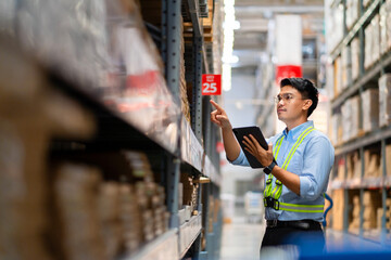 Warehouse manager uses a tablet computer to monitor products in the warehouse. Logistics and export concepts.