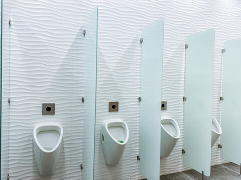 urinals in the city toilet, men's toilet, separate cubicles, public room, restroom, automatic flush sensors.