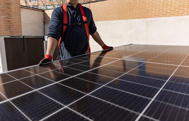 closeup detail of technical worker holding solar panel