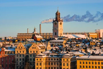 Foto auf Acrylglas Stockholm Rooftop view of the old town and The German church in Stockholm, Sweden, on a cold winter day, snow and morning sunshine.