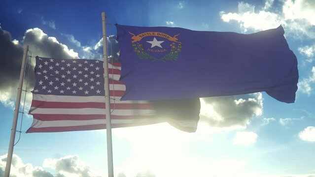 The Nevada state flags waving along with the national flag of the United States of America. In the background there is a clear sky