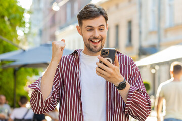 Excited bearded man use mobile smartphone celebrating win good message news, success, lottery...