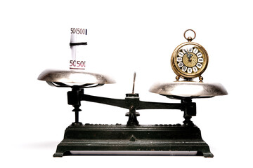 A balance compares the weight of money with the weight of time, job versus leisure time