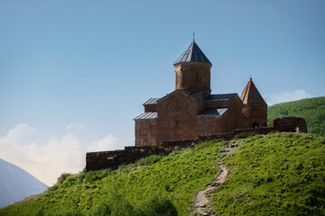 Close view of Holy Trinity Church in Kazbegi mountain range near Stepantsminda view Caucasus mountains in the background