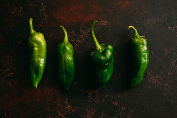 Green peppers on dark background. Healthy eating, vegan food concept